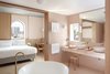 Modern home with Bath Room, Vessel Sink, Ceiling Lighting, Freestanding Tub, Wall Lighting, Limestone Floor, Marble Counter, Ceramic Tile Floor, Ceramic Tile Wall, and Soaking Tub. "Great hotels have stories that go beyond providing a bed for the night—they offer moments of discovery, unexpected adventures, encounters to be savored and retold," says The Calile Hotel, and we wholeheartedly agree. Careful consideration has been put into every detail of this pastel-hued oasis in the middle of Brisbane. Allow your mind to wander as you relax by the pool, lounge at the hotel bar, or simply enjoy the impeccably-designed interior spaces. Photo 8 of The Calile Hotel