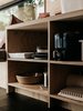 Modern home with Kitchen. Most of the interior, including the walls and storage, is made of Chilean pine plywood, which Ryan chose for its durability and lack of knots. Each sheet, purchased at Lowe’s, cost $20. Photo 13 of Elsewhere Cabin Retreat