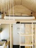 Ryan fashioned the sconces in the sleeping loft for about $10 each. “The electrical was the most daunting task but also the most rewarding,” he says. “When you plug in a light and turn it on, it’s momentous.” His electrical work was later certified by a pro. Photo 20 of Elsewhere Cabin Retreat modern home