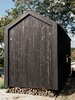 Modern home with Exterior, Gable RoofLine, Wood Siding Material, and Cabin Building Type. With prices starting in the low five figures, pretreated shou sugi ban siding was out of the question. "My girlfriend and I spent a week cutting, trimming, burning, scrubbing, and oiling the cedar ourselves," says Ryan. The project cost a total of $550 in materials. Photo 6 of Elsewhere Cabin Retreat