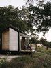 Modern home with Exterior, Cabin Building Type, Gable RoofLine, Wood Siding Material, Tiny Home Building Type, and Metal Roof Material. Ryan McLaughlin watches the sunset from the deck of the 160-square-foot tiny home he built, with no prior experience, at his parents’ horse ranch in Georgetown, Texas. Soon, the trailer-mounted cabin will be moved to a vineyard, where it will operate grid-free and be available to rent for short stays.
Photo 2 of Elsewhere Cabin Retreat