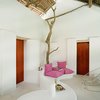 Modern home with Living Room, Chair, Bench, Sectional, and Carpet Floor. "The Habita mini-empire, comprising Mexico City’s Habita and Condesa DF, as well as Playa del Carmen’s Deseo and Basico, expands yet again: This time to Veracruz, near San Rafael, a little beach town that makes Playa del Carmen look like the big city by comparison," says Tablet Hotels. "It’s the perfect place for another design-savvy eco-retreat, sort of in the same vein as the largely recycled Basico, only more basic—instead of post-industrial concrete and oil tanks, here we’re back to thatched-roof bungalows, albeit ones with crisp all-white contemporary bedrooms inside." Photo 9 of Hotel Azúcar