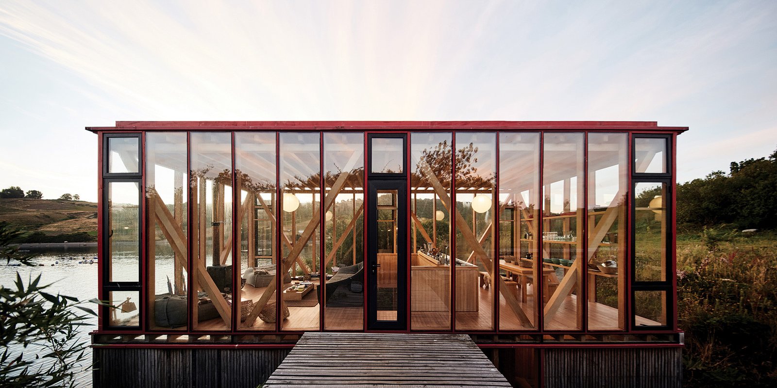 In Chile's Chiloé Archipelago, architect Guillermo Acuña developed a 12-acre island for his friends and family to unwind, first with a boathouse, later with pathway-connected cabins at the water's edge. Design details include glazed walls, eco-friendly pine, and a bright red palette that calls to mind the intensely colored chilco flowers that bloom here come spring and summer. 