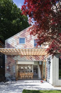 Karen James and Daniel Freeman’s home is a vibrant new addition to a block of midcentury bungalows in Vancouver, British Columbia. One of the volumes is clad in untreated tongue-and-groove Western red cedar. The other is covered in multicolored cedar shakes, which are skewed at an angle that aligns with the slope of the roof. Architect Clinton Cuddington of Measured Architecture worked with the owners to fine-tune the unconventional pattern and color palette.