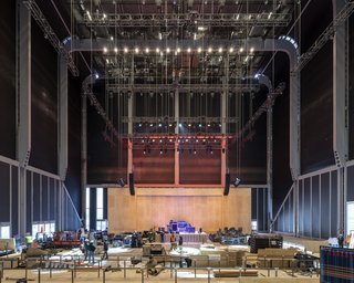 Blackout shades drawn over The McCourt create an auditorium setting.