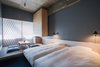 Modern home with Bedroom, Bed, Wall Lighting, Track Lighting, Rug Floor, Carpet Floor, and Storage. The Share Hotels Kumu Kanazawa in Kanazawa, Japan Photo 8 of The Share Hotels Kumu Kanazawa