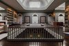 The original staircase leads up to the library, which is crowned with a skylight. Known as a claraboia, it is an architectural hallmark of numerous Porto townhouses. Photo 2 of Torel 1884 Suites & Apartments modern home