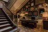 Modern home with Staircase, Wood Tread, and Wood Railing. Fans, textiles, and illustrations behind the reception desk, adjacent to the palace's original staircase, transport guests to Africa upon entry. Photo 3 of Torel 1884 Suites & Apartments