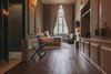 Modern home with Bedroom, Bed, Chair, Table Lighting, Wall Lighting, and Dark Hardwood Floor. Light, ethereal tones dominate the "Sugarcane" room, which showcases elegant details including handmade tassels adorning the wardrobe's doors. Photo 8 of Torel 1884 Suites & Apartments