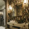 Modern home with Bath Room and Wall Lighting. Bold, whimsical wallpaper exemplifies the "Exotic Birds" room. Photo 6 of Torel 1884 Suites & Apartments