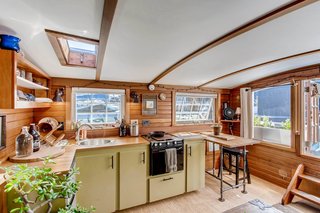 The kitchen features butcher-block countertops and a skylight, which allows for a naturally lit workstation.