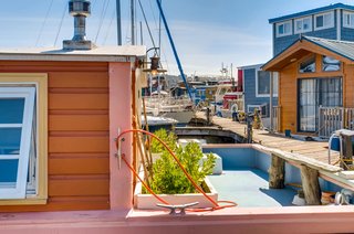 While the houseboat has two decks, the larger one—which can be easily accessed from the kitchen/living room—has a secured container garden, along with a handmade driftwood bench.