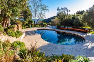 The other pool, surrounded by the meticulously manicured landscape. Immersed in breathtaking ocean and canyon vistas, this serene spot feels worlds away from the city.