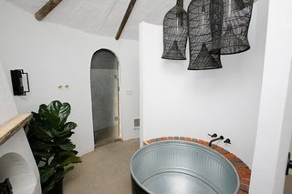 The soaking tub is nestled right next to the fireplace.