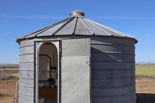 The bathroom is located in a converted silo, sited right next to the potato.