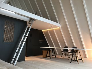 In the kitchen, the cooking unit blends into a black wall.