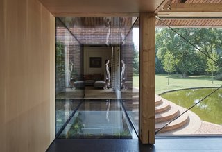 Connected to the main home by a structural glass bridge, the new buildings provide additional living space and guest accommodations. <span style="color: rgb(204, 204, 204); font-family: Theinhardt, -apple-system, BlinkMacSystemFont, "Segoe UI", Roboto, Oxygen-Sans, Ubuntu, Cantarell, "Helvetica Neue", sans-serif; font-size: 13px;">Photo by James Brittain Photography</span>