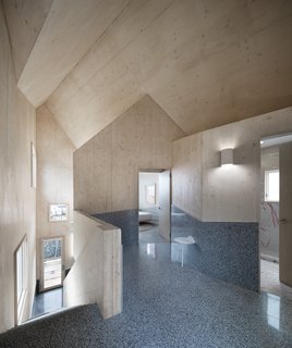 A cluster of six gable roofs combined to form a single abode, the single-family home is organized by the roof plan.
