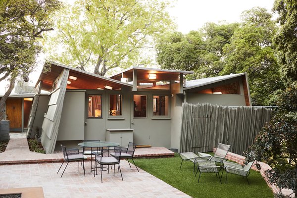 This classic owned by writer Susan Orlean and her husband John Gillespie was updated by architect Jeff Fink, who specializes in restoring homes by Austrian-born architect Rudolph W. Schindler. The couple has previously owned his Los Angeles Roth house, buying it even though they lived in New York. Then, they sold it for the Kallis-Sharlin House, known for its butterfly roof—which allowed Schindler to add clerestory windows, and more light to the home. For the exterior, they ordered a custom hue from Behr, channeling the grey-green of a Martini olive.