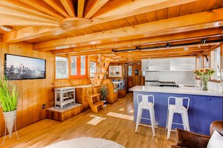 Clad in beautiful oak, the recently restored home has 812 square feet of bright interior space. The kitchen has Corian counters, stainless steel appliances, and a deep sink.