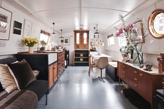 A look at the front half of the boat. The galley kitchen has been assembled from a reclaimed chest, an iroko hardwood worktop from Retrouvius, and bespoke cupboard doors made from western red cedar.