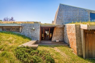 A look at the front entrance of the residence. The home's striking sod roof effortlessly blends the property into its lush surroundings.