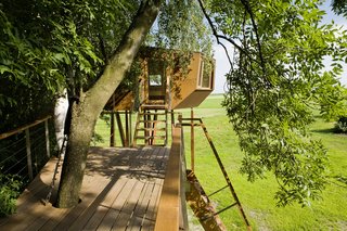 After various design studies, the team created plans to connect the house to a long terrace. Perched above a small brook, the slender deck offers a calm setting to connect with nature. 