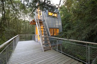 The wooden terrace covers 118 square feet, offering plenty of space for visitors to watch the wildlife roaming throughout the area. Featuring a curved roof window, the house's upper room provides a spectacular space to stargaze at night.