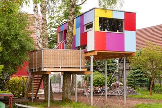 Known as St. Martin, this colorful tree house serves as a habitat and development center for children and adolescents with cognitive impairments. By collaborating with a garden architect, the team developed a spectrum of colors for the playful, patchwork-like facade.