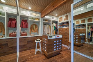 The master suite also includes a spacious walk-in closet with restored cabinetry.