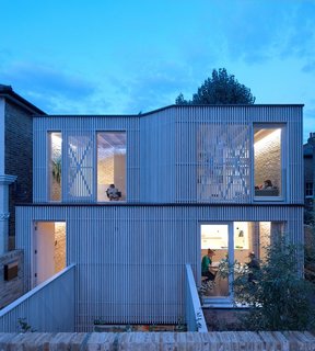 A minimal material palette of exposed brick, light timber, and concrete was designed to create a sense of calm and cool in this stacked family home.