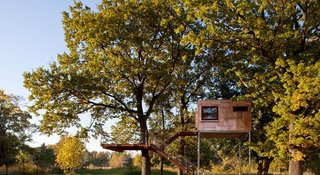 Located near Berlin, Germany, Copper Cube is a tree house with an integrated bathroom, minibar, and large bed.