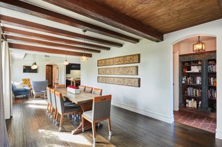 The natural wood beams and ceilings continue into the formal dining area.