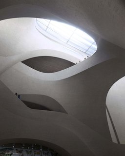 A vast skylight from above will brighten the central exhibition hall with its undulating arches of reinforced concrete.