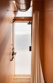 Fittings and mechanics are left exposed inside the home, enhancing its simplistic aesthetic. 