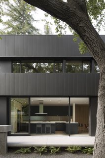 A peek into the sleek, spacious kitchen, featuring floor-to-ceiling sliding doors.