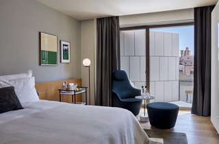 This street-facing guest room is sheltered behind the building's curvaceous facade.