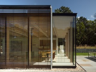 The holiday home has been configured using a series of "dematerialized" modules, which "highlights the tactile qualities of the carefully curated palette of materials: unadorned wood, glass, and concrete."
