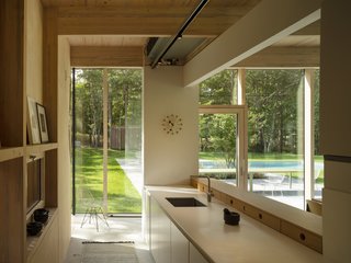 Wood finishes continue into the light-filled kitchen, which is just steps away from the pool.