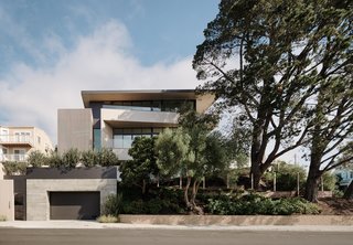 The highly glazed exterior is balanced using cedar plank cladding and large pine trees to provide privacy and filter sunlight. 