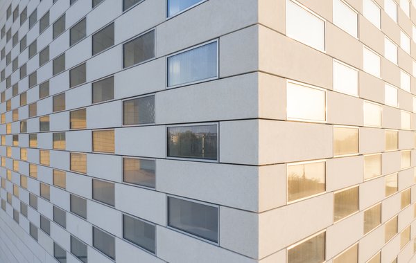 The facade is composed of 4,800 concrete slabs interspersed with glass.