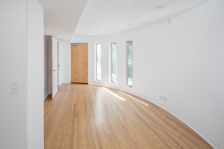 A bedroom with en-suite bathroom is located on the lower level, which can easily be converted into a home office, recording studio, or cozy den—depending on your needs.