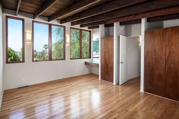 Exposed wooden beams and beautifully restored midcentury detailing create the illusion of stepping back in time.