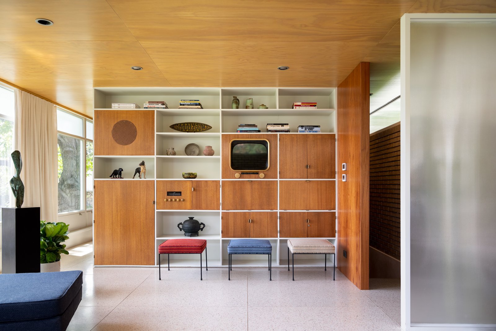 With the same materials that were used originally—like the mahogany and Douglas fir in the living room—Dominick and Scott sensitively restored the interior. Knoll fabrics cover the vintage Paul McCobb stools.