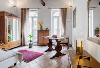 Elegance and leisure unite in this light-filled apartment, complete with historic exposed-beam ceilings and French doors that let fresh air permeate the space.