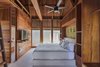 Modern home with Bedroom, Concrete Floor, Bed, and Storage. The guest rooms were all built from Western red cedar, which was sourced from the family's plantation. Photo 3 of Punta Caliza