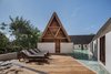 Modern home with Outdoor, Trees, Decking Patio, Porch, Deck, Wood Fences, Wall, Swimming Pools, Tubs, Shower, Side Yard, Small Pools, Tubs, Shower, Plunge Pools, Tubs, Shower, Landscape Lighting, Stone Fences, Wall, Wood Patio, Porch, Deck, Small Patio, Porch, Deck, and Hanging Lighting. "Running a business with your family is complicated, but being back together after six or seven years of living on our own has been a beautiful experience," she says. Photo 5 of Punta Caliza