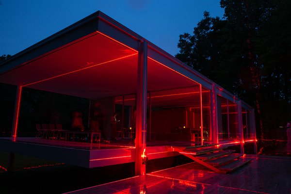 The red laser beams light the home at night, giving it a new, unique aesthetic. 