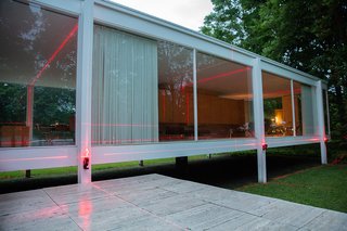 The International Style home is framed anew by carefully placed laser beams, creating a fully immersive experience inside the home and out. 