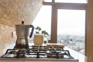 The kitchenette has a stove and an oven, and enough counter space for home cooking. 
